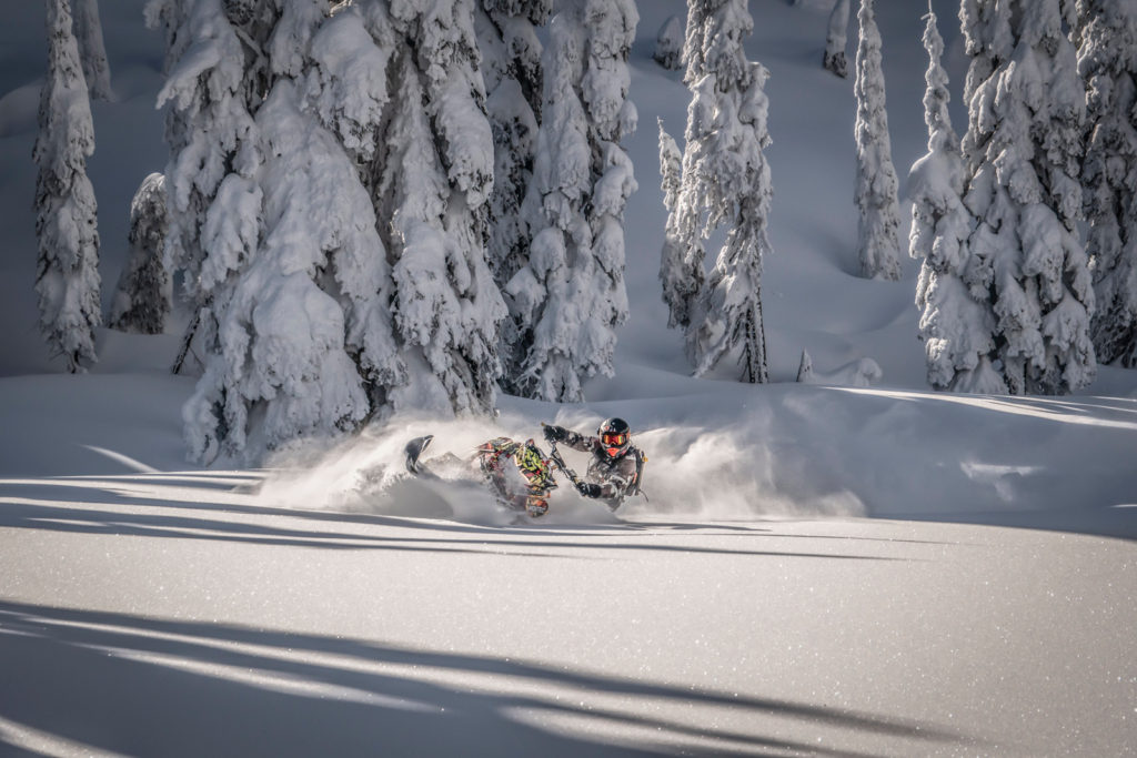 Snowmobiler in deep powder snow.